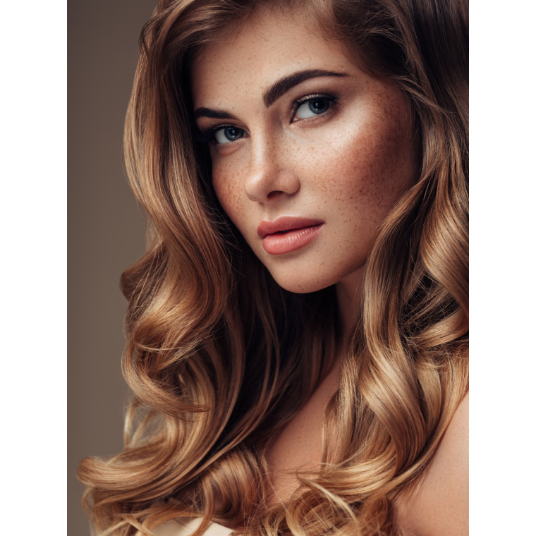 Young beautiful model with long wavy well groomed hair