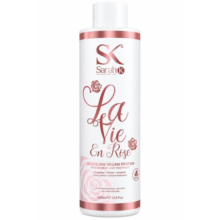 Sarah K Professional Hair La Vie en Rose Brazilian Vegan Protein is een professionele gladmakende en verzorgende behandeling voor haar dat pluizig, volumineus, droog of moeilijk handelbaar is. De behandeling helpt de haarvezel gladder en zachter te maken, vermindert ongewenst volume en geeft het haar meer glans en controle. 1. Analyseer het haar Controleer vóór de behandeling altijd de conditie van het haar. Let op porositeit, elasticiteit, dikte, eerdere kleuringen, ontkleuringen en andere chemische behandelingen. Voer bij blond, geblondeerd, poreus, beschadigd of chemisch behandeld haar altijd eerst een pluktest uit. Wanneer het haar extreem elastisch, breekbaar of sterk beschadigd is, wordt aangeraden de behandeling uit te stellen. 2. Haar voorbereiden Was het haar grondig met een diep reinigende of clarifying shampoo zodat resten van stylingproducten, talg en andere ophopingen worden verwijderd. Bij veel productopbouw kan het haar indien nodig tweemaal worden gewassen. Gebruik vóór de behandeling geen conditioner of zwaar masker. Spoel het haar goed uit en verwijder overtollig water. 3. Haar verdelen Droog het haar indien nodig gedeeltelijk en verdeel het vervolgens in vier tot zes werkzones. Werk steeds met kleine, dunne lokken. Dit zorgt voor een gelijkmatige verdeling van het product en een beter eindresultaat. 4. La Vie en Rose Brazilian Vegan Protein aanbrengen Draag professionele beschermende handschoenen. Breng het product lok voor lok aan en blijf ongeveer 1 cm van de hoofdhuid verwijderd. Verdeel de Brazilian Vegan Protein gelijkmatig over de lengtes en punten. Kam iedere lok zorgvuldig door met een fijne kam zodat overtollig product wordt verwijderd. Het haar moet goed bedekt zijn, maar hoeft niet zwaar verzadigd te zijn. 5. Inwerktijd Laat het product ongeveer 40 tot 45 minuten inwerken. Bij fijn, poreus of sterk chemisch behandeld haar moet de conditie regelmatig worden gecontroleerd. De exacte inwerktijd kan worden aangepast aan de weerstand en structuur van het haar. 6. Uitspoelen Spoel na de inwerktijd het overtollige product zorgvuldig uit met water. Gebruik tijdens deze stap geen shampoo. Spoel gelijkmatig zodat er geen zware productophoping in het haar achterblijft. 7. Haar volledig föhnen Föhn het haar daarna volledig droog. Het haar moet vóór het gebruik van de stijltang 100% droog zijn. Föhn het haar zo glad mogelijk in de gewenste richting. Hierdoor is tijdens het sealen minder onnodige hitte nodig. 8. Temperatuur van de stijltang De temperatuur moet altijd worden aangepast aan de conditie van het haar. Als professionele richtlijn kan worden gewerkt met ongeveer 170–180°C bij zeer gevoelig, poreus of sterk geblondeerd haar, 180–200°C bij fijn, gekleurd of chemisch behandeld haar, 200–220°C bij normaal en gezond haar en maximaal ongeveer 220–230°C bij dik, sterk en zeer resistent natuurlijk haar. Gebruik bij twijfel altijd eerst een lagere temperatuur. 9. Sealen met de stijltang Verdeel het volledig droge haar opnieuw in kleine zones. Neem zeer dunne lokken en werk systematisch vanaf de nek naar boven. Ga gecontroleerd met de stijltang over iedere lok. Het aantal passages moet worden aangepast aan de conditie van het haar. Gezond en resistent haar kan meer passages verdragen dan fijn, blond, poreus of chemisch behandeld haar. Werk bij gevoelige lengtes en punten altijd met minder warmte en minder passages. Blijf nooit met de stijltang stilstaan op één plaats. Extra belangrijk bij blond en beschadigd haar Werk bij blond, geblondeerd of zeer poreus haar nooit automatisch op de maximale temperatuur. Begin met een lagere temperatuur en controleer voortdurend hoe de haarvezel reageert. Wanneer het haar tekenen van overmatige elasticiteit, breuk of verzwakking vertoont, moet de behandeling worden gestopt. Resultaat Bij een correcte professionele toepassing wordt het haar gladder, zachter en beter handelbaar. Pluis en ongewenst volume worden verminderd en het haar krijgt meer glans en een verzorgde uitstraling. Het uiteindelijke resultaat is afhankelijk van het oorspronkelijke haartype, de conditie van het haar, de gebruikte temperatuur en de applicatietechniek. Onderhoud na de behandeling Gebruik na de behandeling bij voorkeur een milde professionele shampoo en conditioner voor behandeld haar. Vermijd agressief reinigende shampoos wanneer u het resultaat zo lang mogelijk wilt behouden. Een hydraterend of voedend masker kan regelmatig worden gebruikt om de zachtheid, soepelheid en glans van het haar te ondersteunen. Voorzorgsmaatregelen Uitsluitend voor professioneel gebruik. Voer vóór gebruik een pluktest uit. Gebruik beschermende handschoenen en werk in een goed geventileerde ruimte. Vermijd contact met de hoofdhuid, ogen en slijmvliezen. Niet gebruiken op een geïrriteerde of beschadigde hoofdhuid. Bij contact met de ogen onmiddellijk overvloedig met water spoelen. Niet gebruiken op extreem beschadigd of sterk breekbaar haar. Buiten bereik van kinderen bewaren en beschermen tegen direct zonlicht en overmatige warmte. Volg bij afwijkende instructies altijd de aanwijzingen op de originele verpakking van Sarah K Professional Hair.